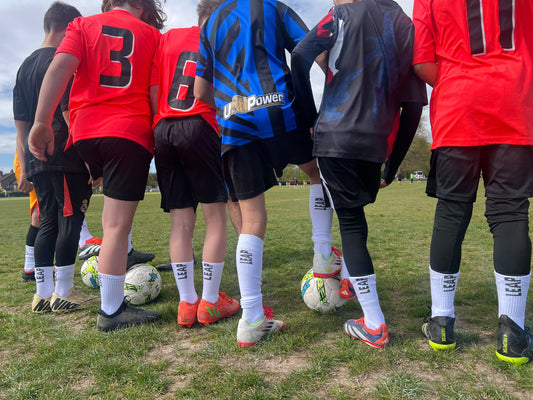 boys playing football wearing LEAP football grip socks.