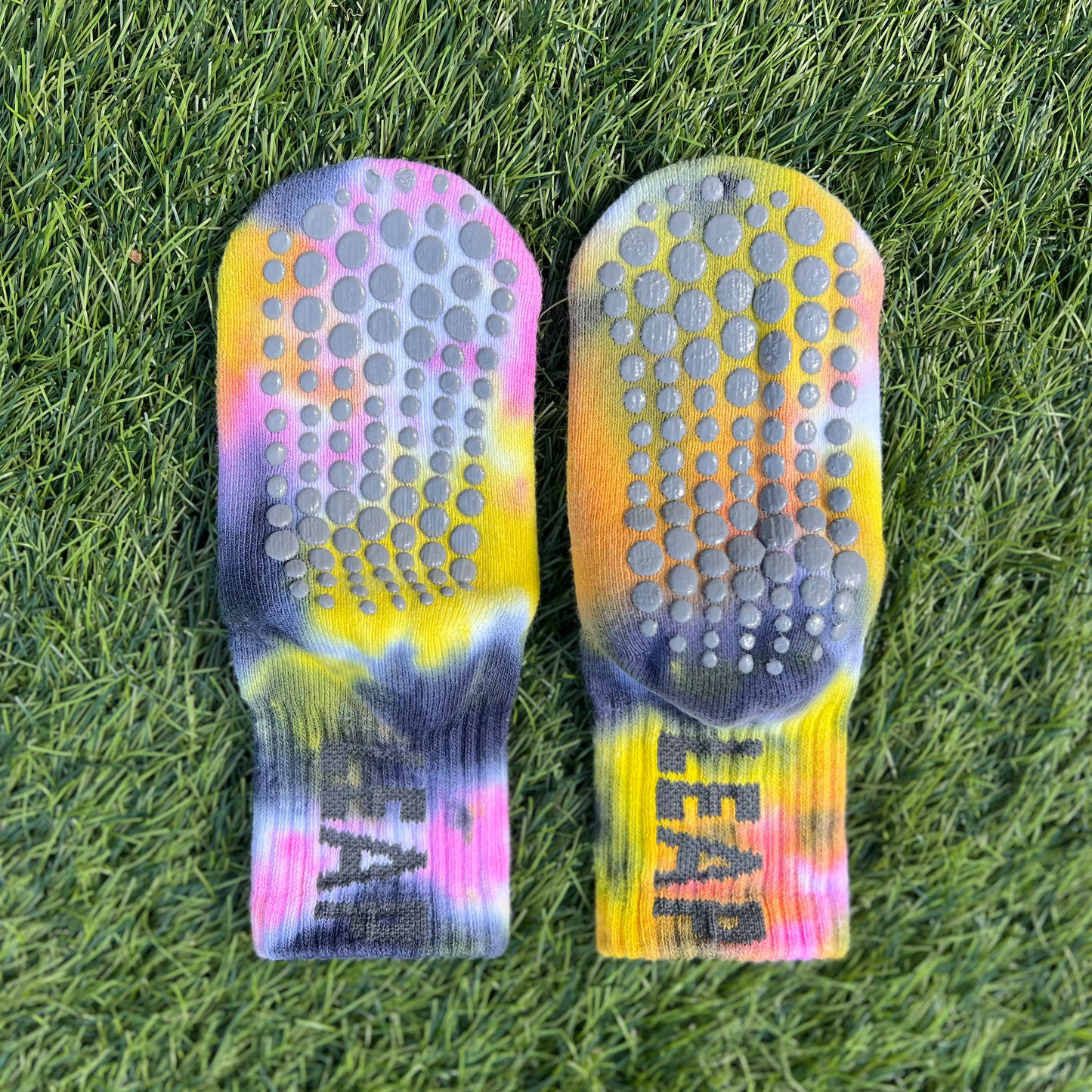 Socks showing underside grip spot soles and LEAP logo.