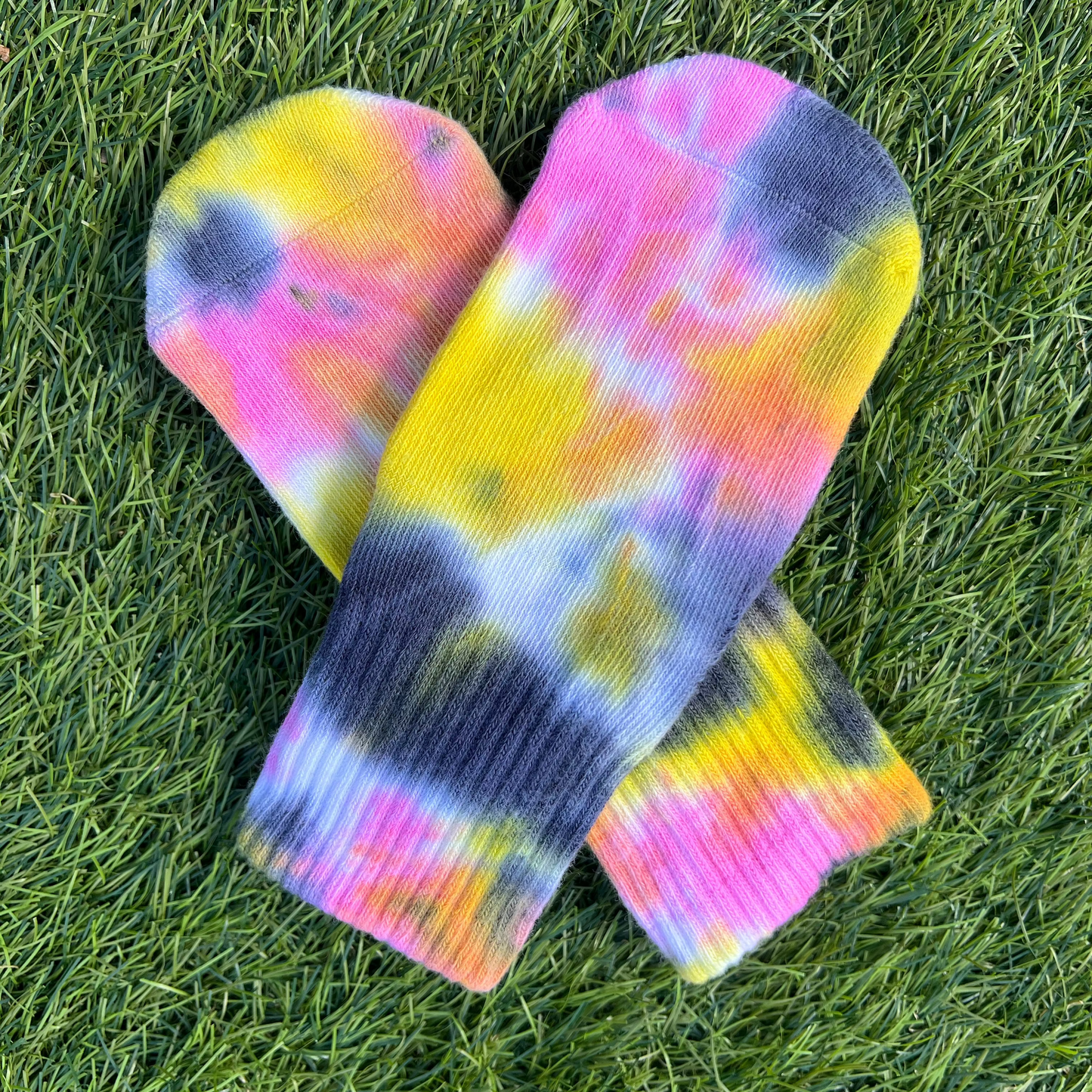 Tie-dye toddler socks in yellow, pink, and grey.