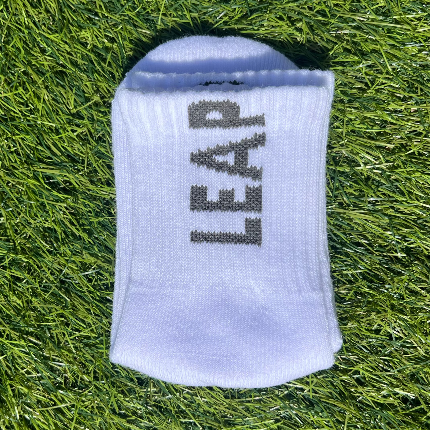 Folded LEAP white football ankle grip socks