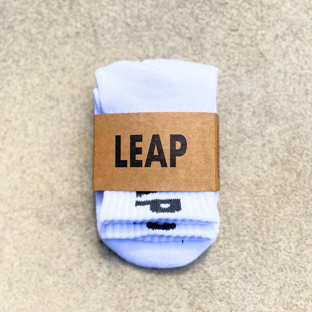 Folded Leap ankle grip socks in packaging.