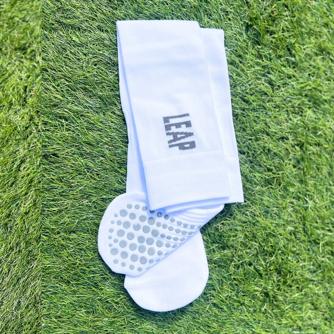 Folded Leap football socks showing the logo and grip sole.